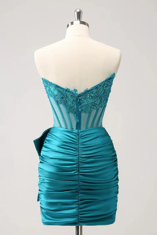 Side view of a woman posing in a sparkly strapless tight short dress.