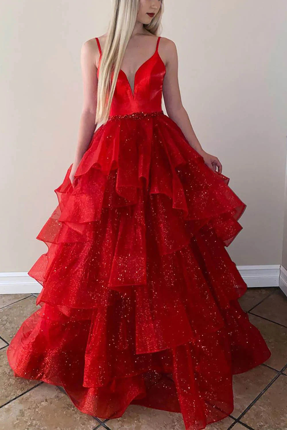 Sparkly tiered tulle prom dress with spaghetti straps, highlighting the fabric detail and flowing silhouette.