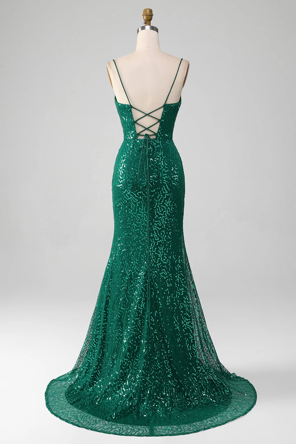 Back view of a model in a dark green sequined A-line prom gown.