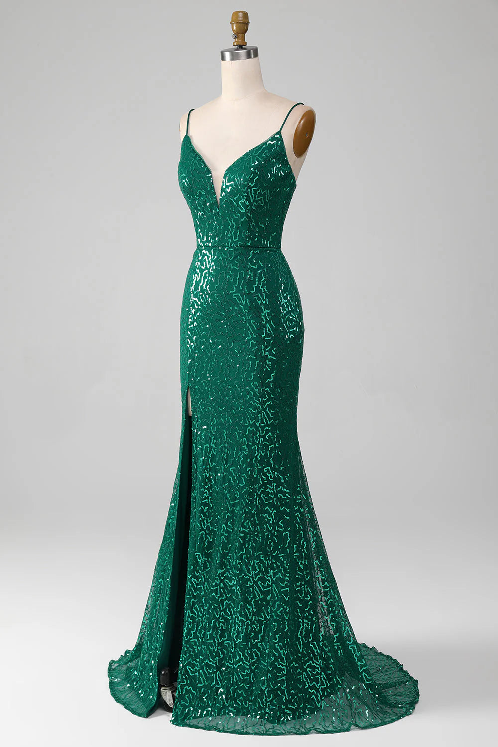 Close-up of the intricate beading and sequins on the dark green prom dress.