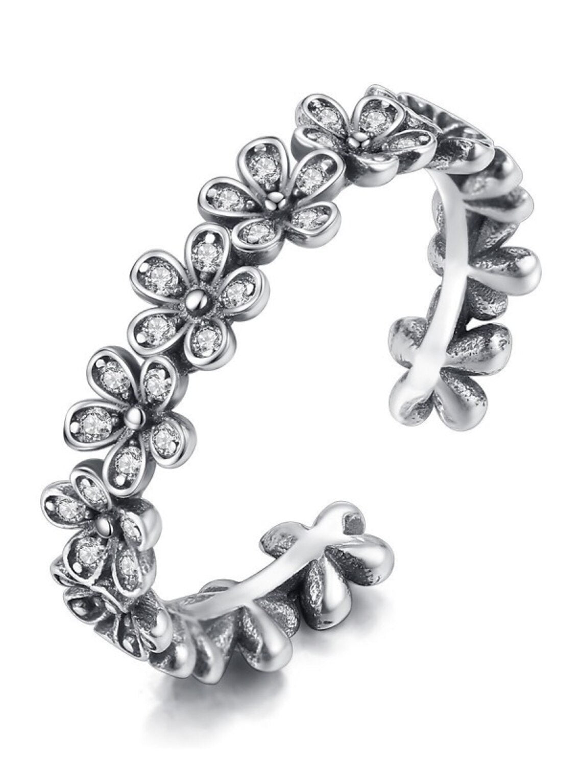 Side view of the sterling silver open ring with flower and zircon.