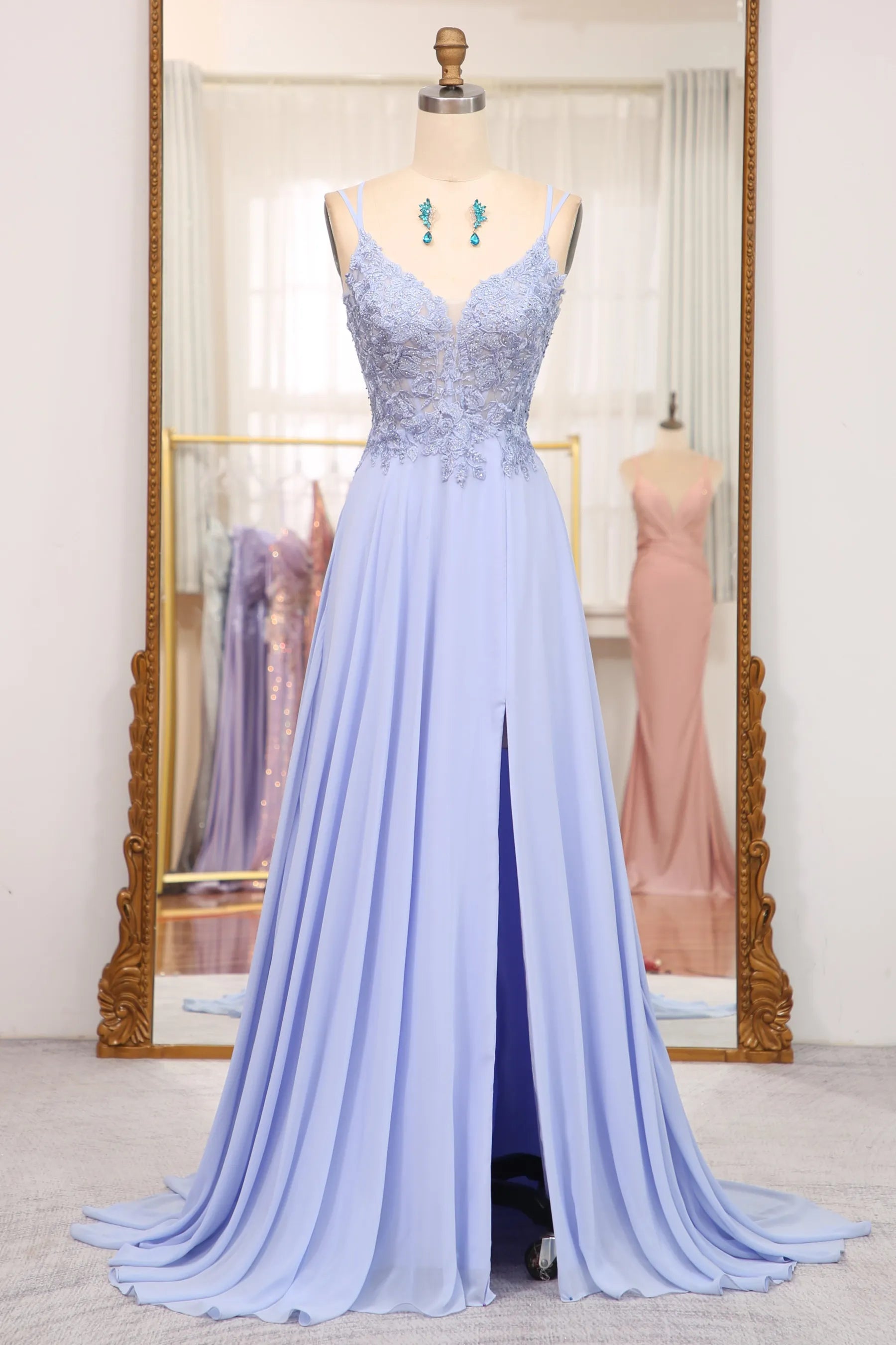 Navy blue A-line prom dress with lace-up back and appliques.