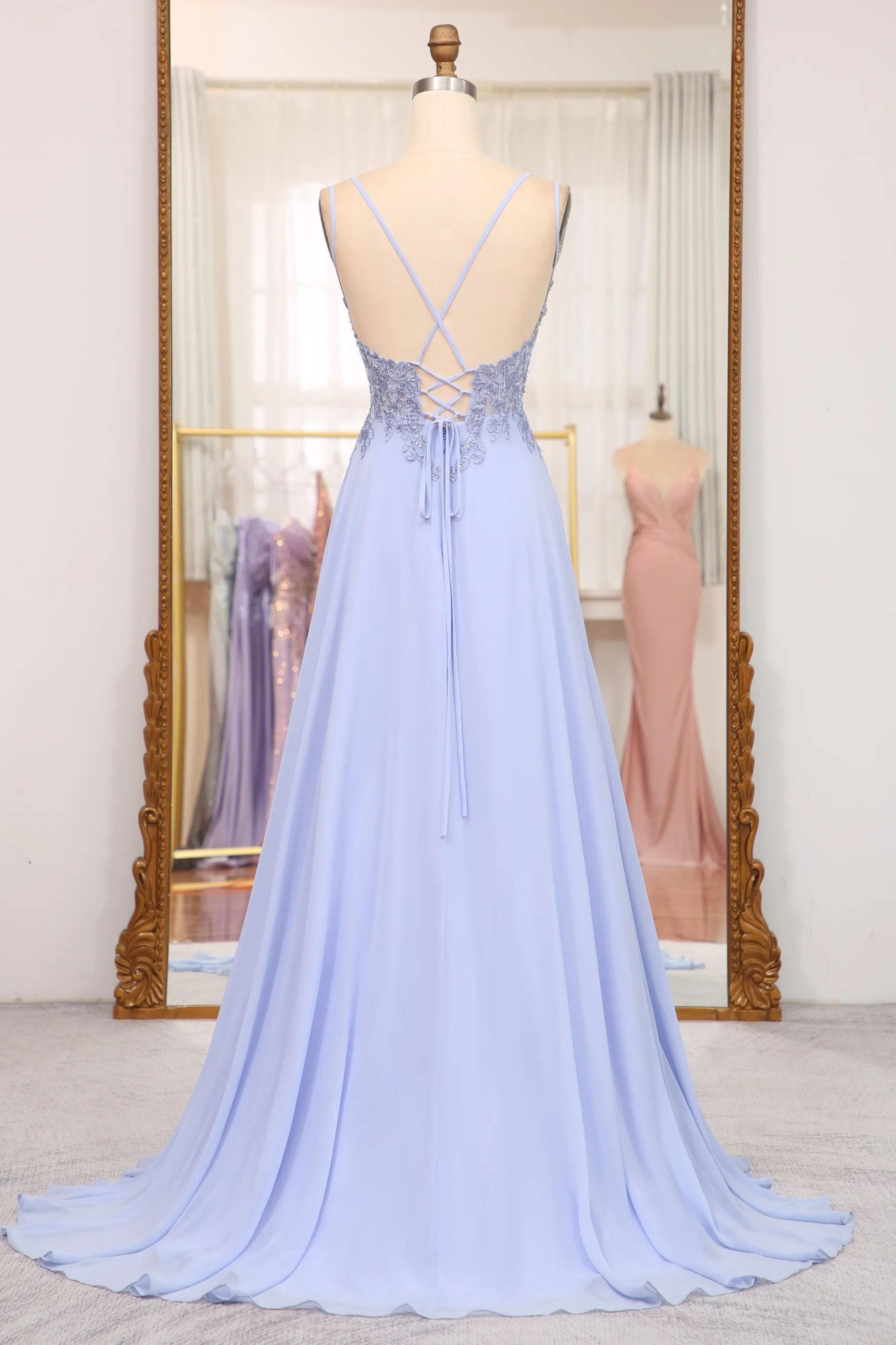 Close-up of the lace-up back detail on a navy blue formal gown.