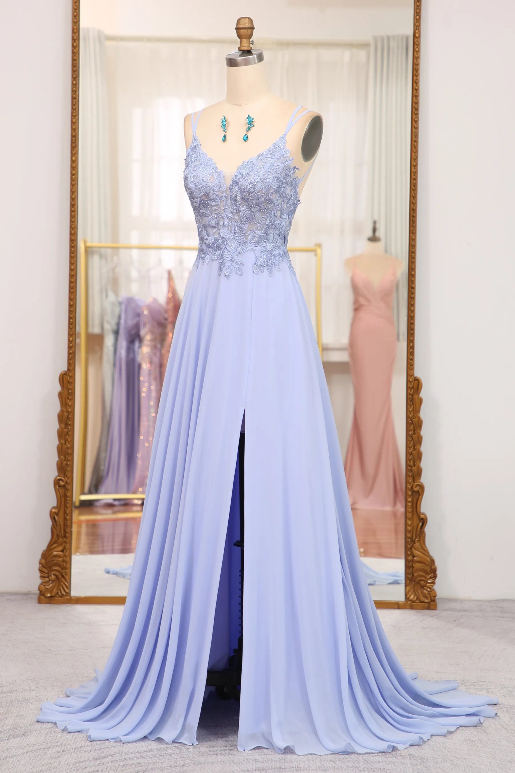 Full view of a woman wearing the long navy blue A-line applique dress.