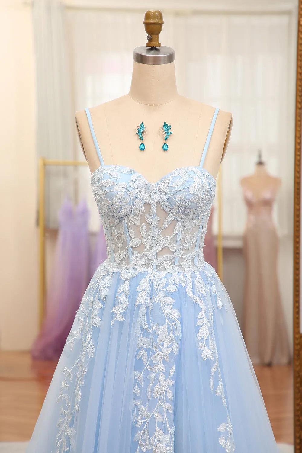 Back view of a sky blue A-line prom dress with appliques.