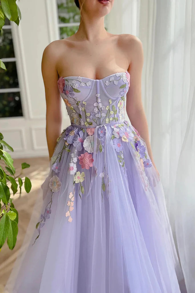 Back view of a stunning A-Line strapless evening gown featuring 3D flowers.