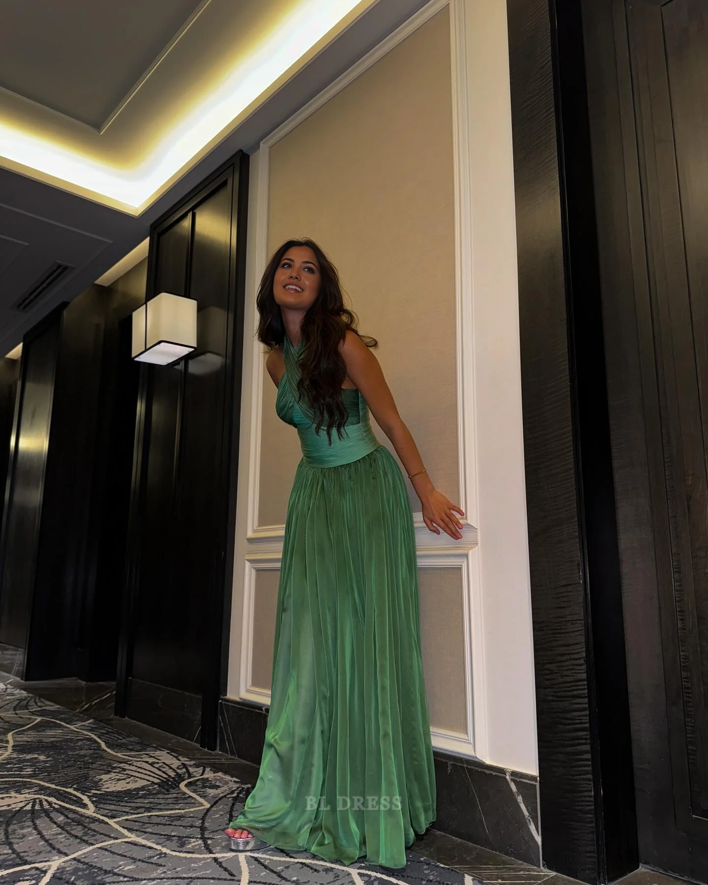 Back view of the green A-line V-neck sleeveless formal dress.