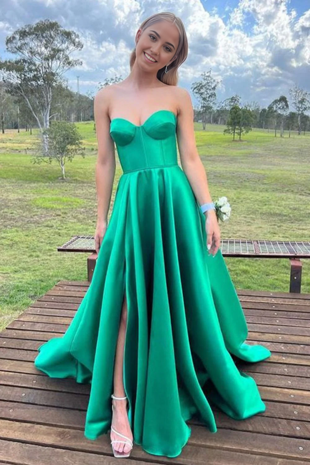 Side view of green V-neck long formal dress on a model.