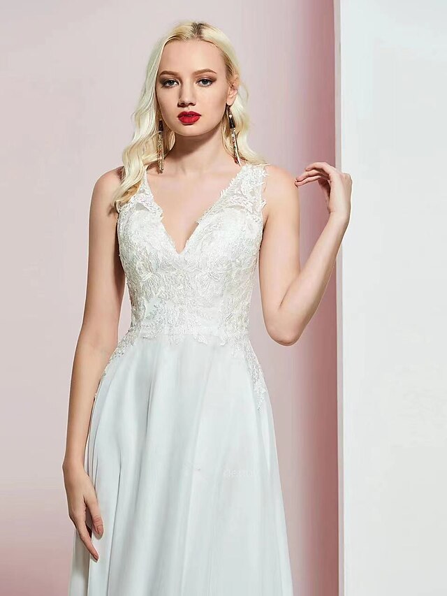 Close-up of the V-neckline and intricate appliques on the gown.