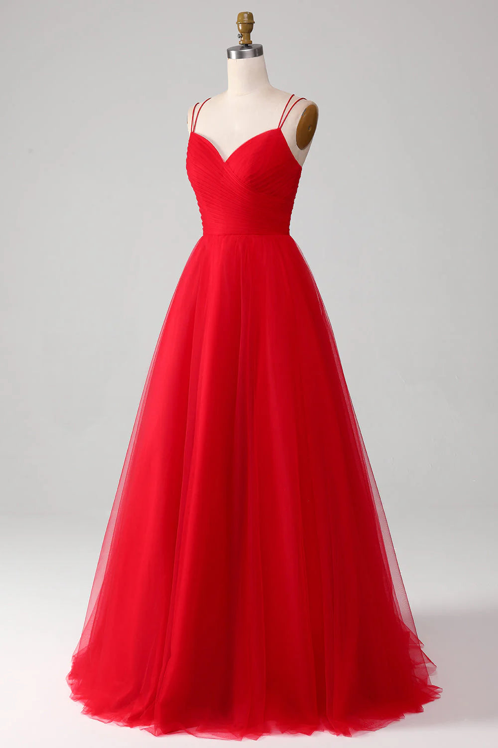 Side view of the flowing red A-line gown, highlighting its long silhouette.