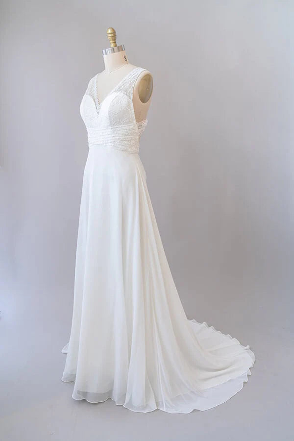 Side view of the long lace chiffon bridal gown.
