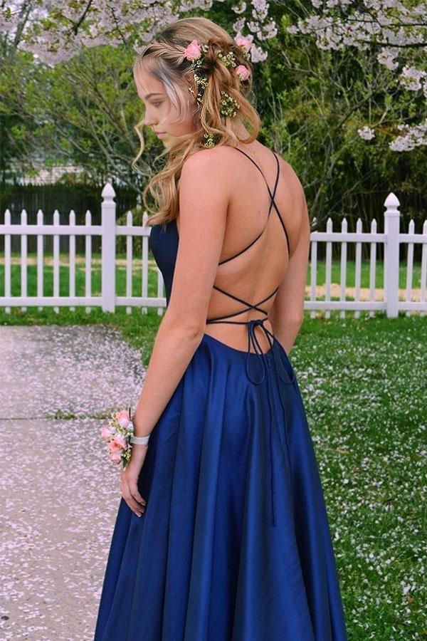 Close-up of the royal blue satin fabric and criss-cross strap detail on the prom dress.