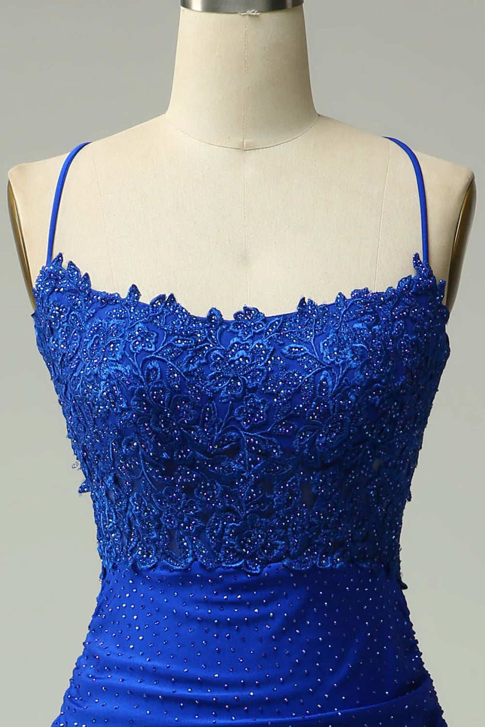 Side view of a royal blue mermaid prom dress, highlighting the elegant silhouette and beading.