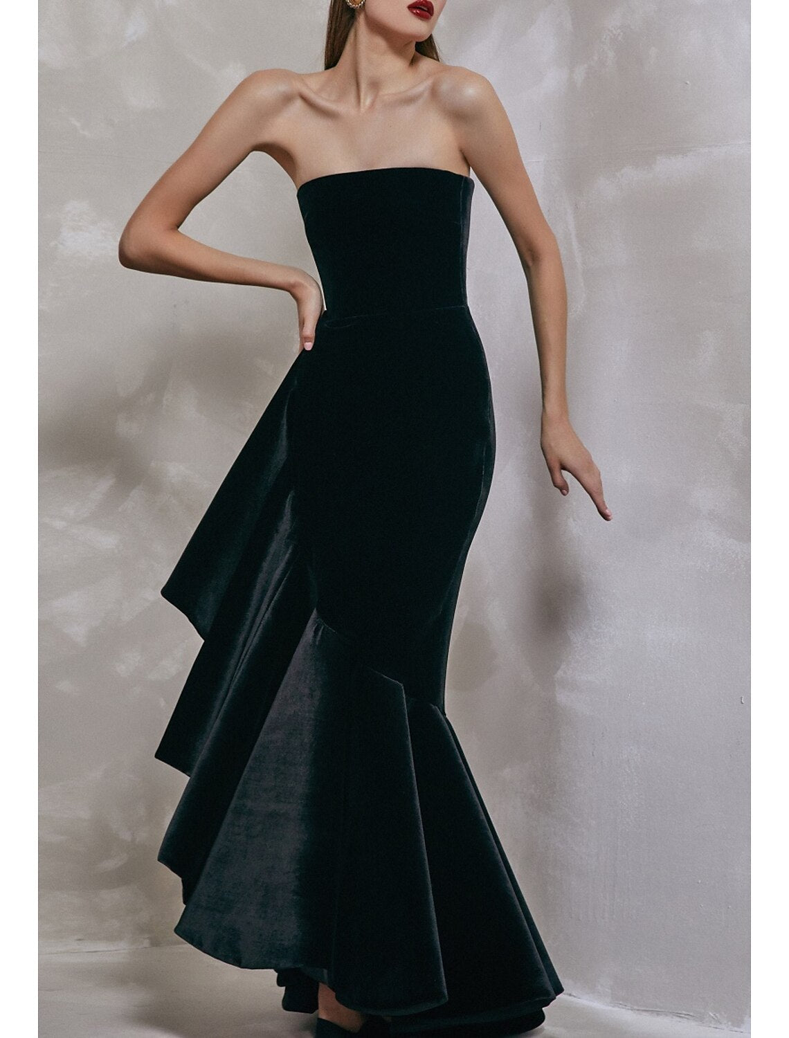 Full length view of a black velvet formal dress.