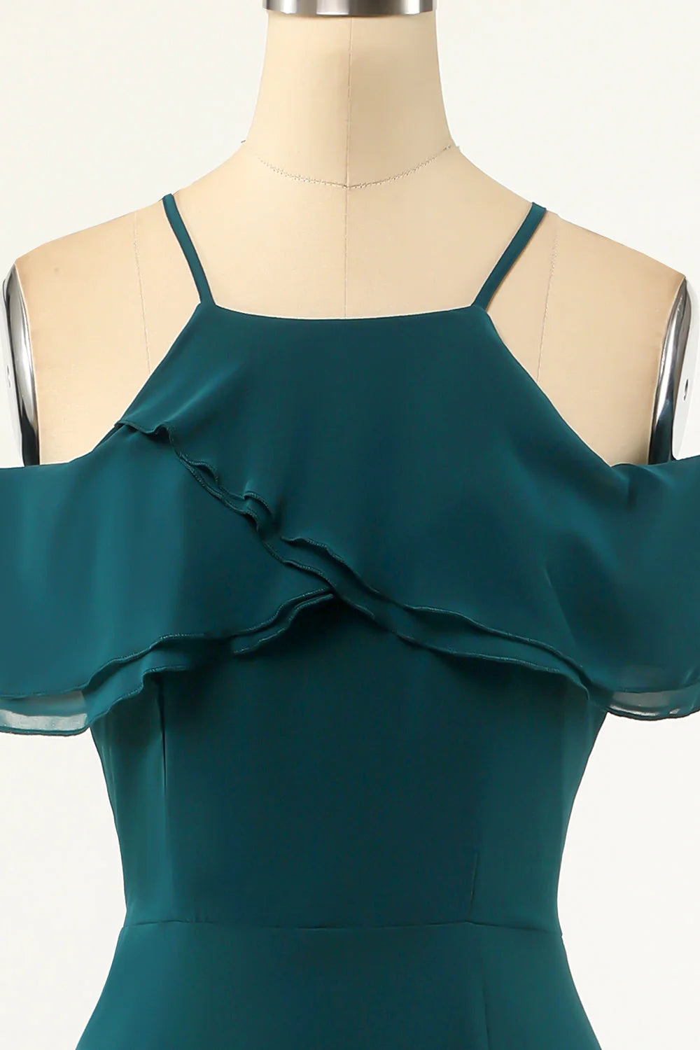 Side view of a green cold shoulder A-line maxi prom dress.