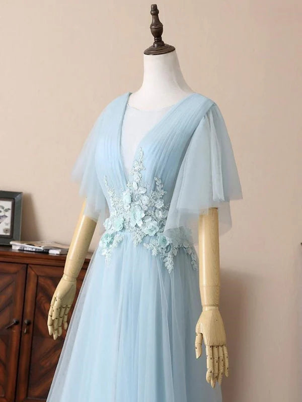 Full length view of the deep V-neck short sleeve prom dress.