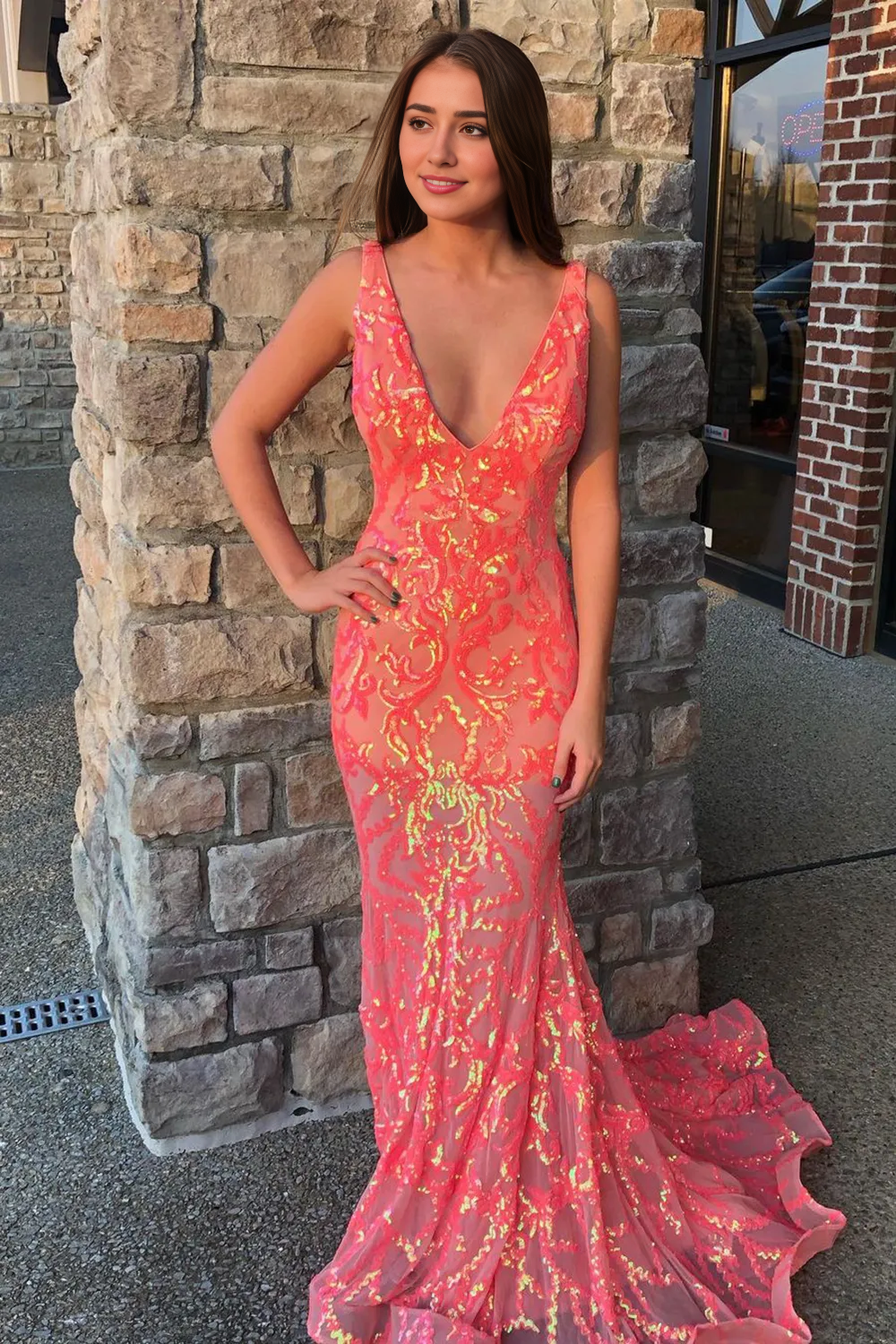 Elegant mermaid prom dress with deep V-neck and intricate embroidery.