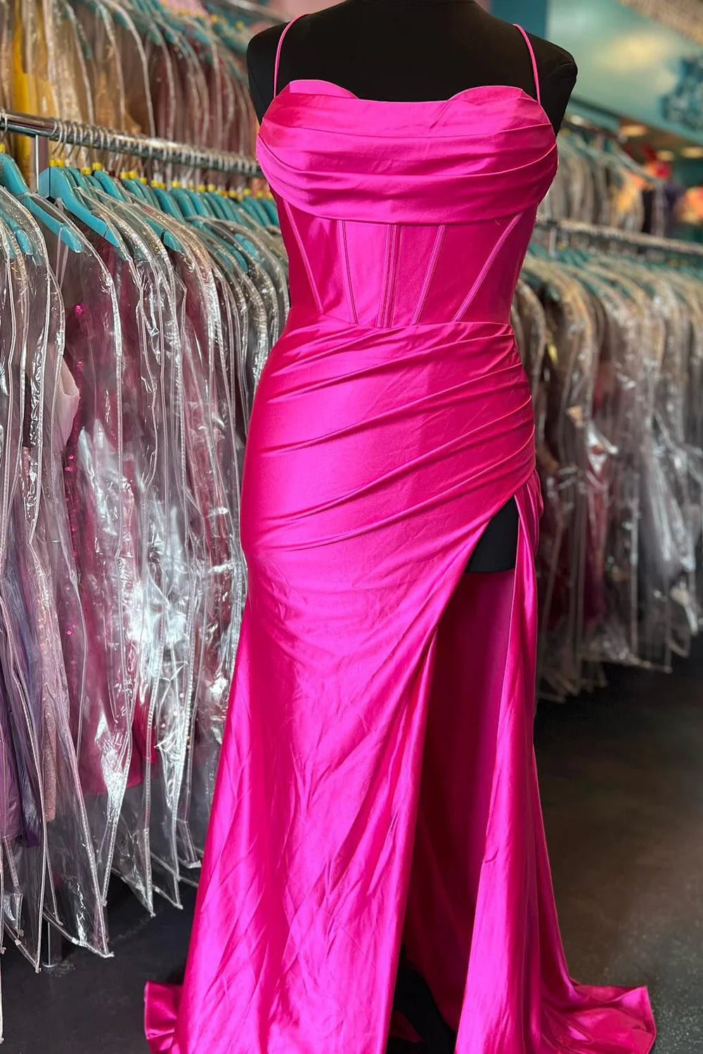 Side profile of the hot pink mermaid prom dress, highlighting the satin fabric.