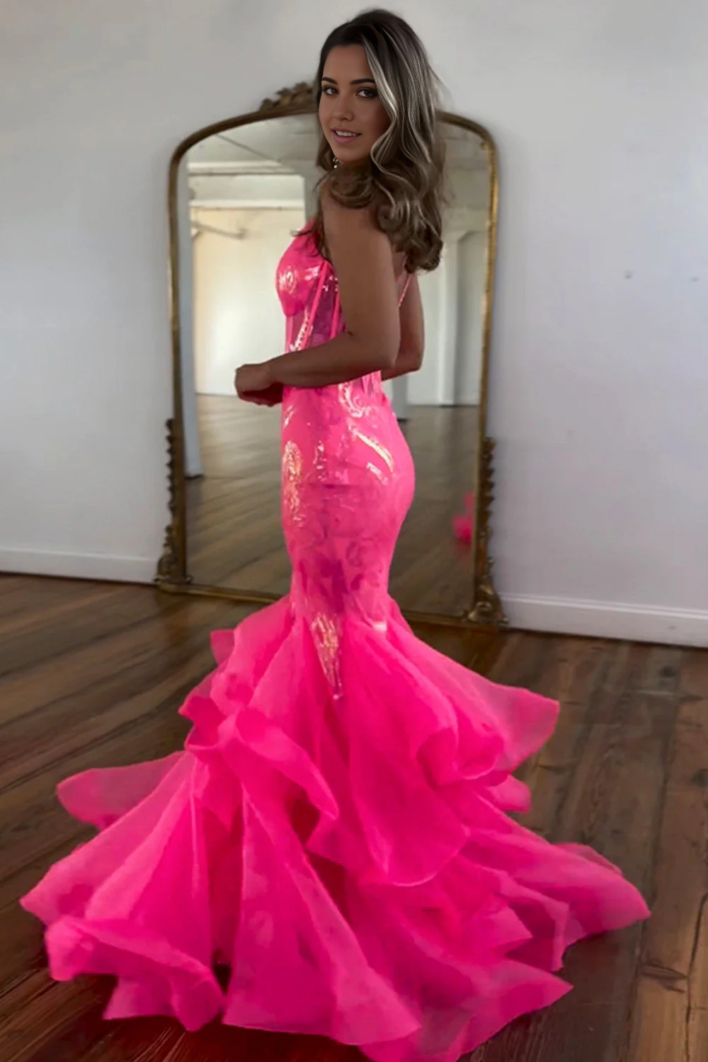 Back view of the hot pink sequin mermaid dress, showcasing the elegant ruffled train.