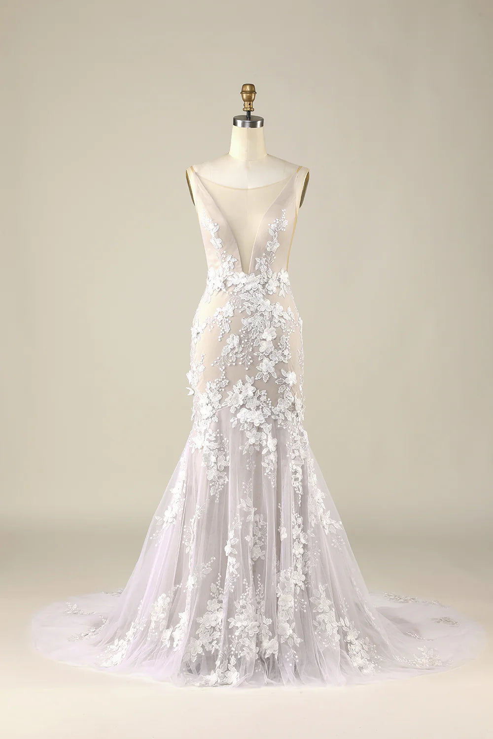 Ivory tulle wedding dress with appliques and backless design.