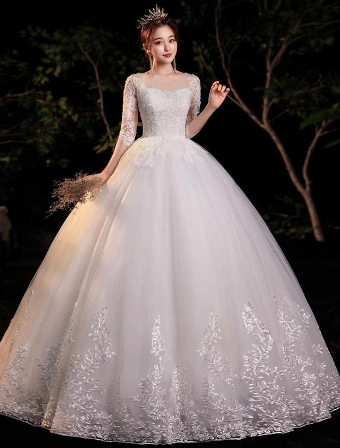 Side view of a bridal ball gown featuring intricate lace appliques and a floor-length skirt.