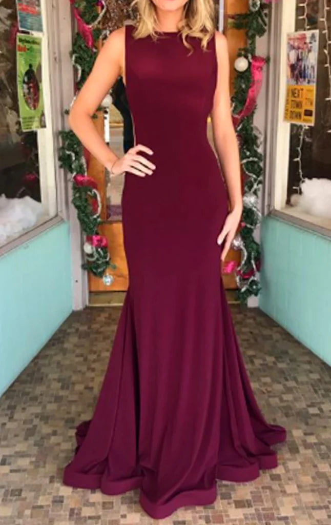 Woman wearing an elegant backless mermaid prom dress.