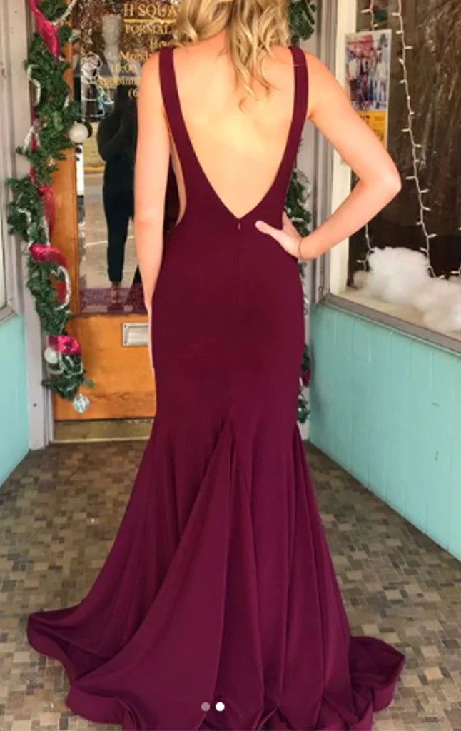 Back view of a woman in a sleek mermaid formal gown.