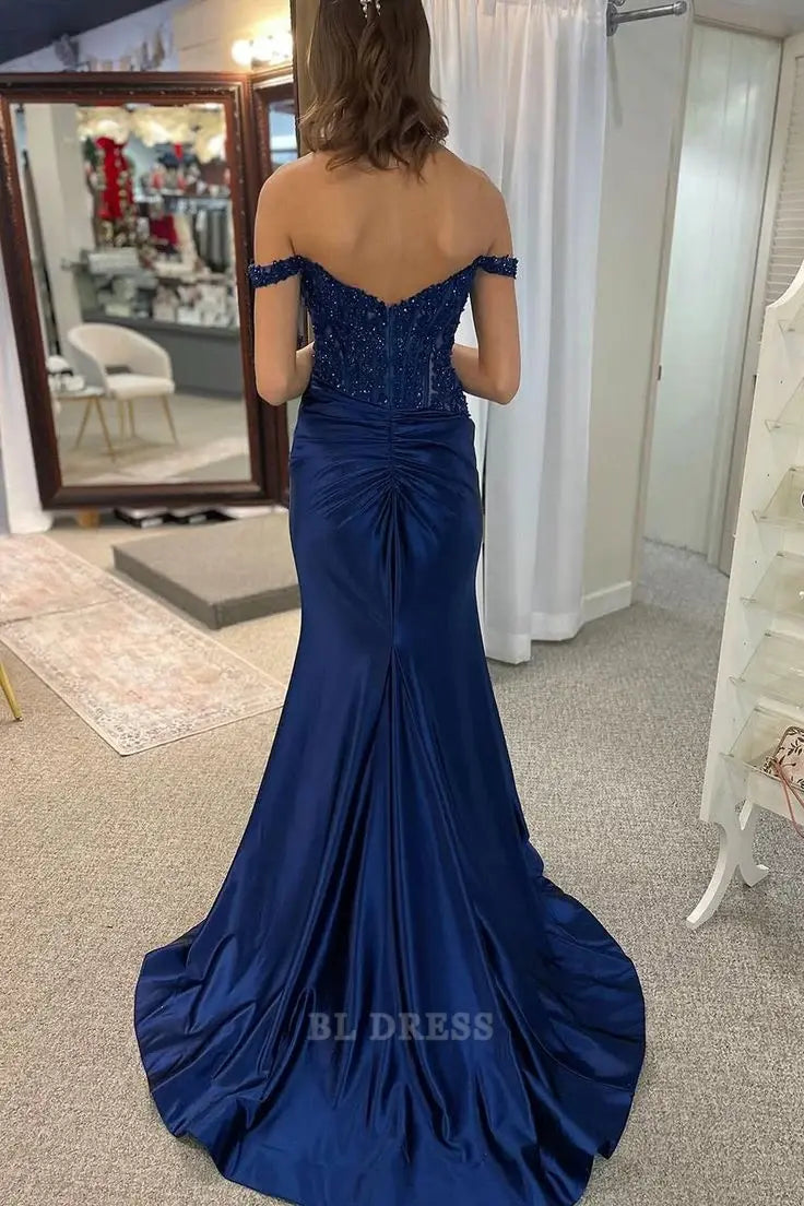 Model posing in an elegant navy blue mermaid off-shoulder dress.