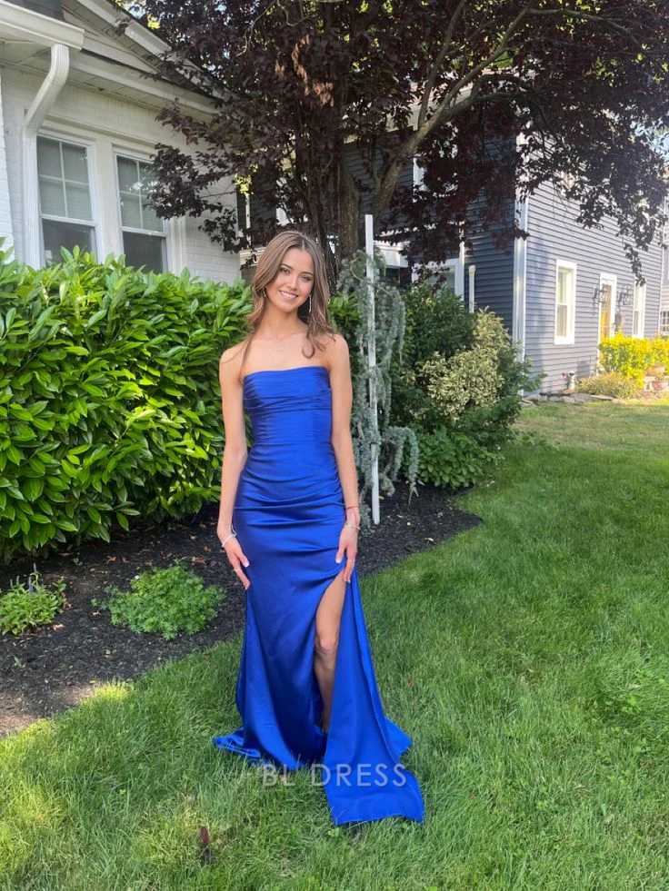 Woman wearing a royal blue strapless mermaid formal gown.