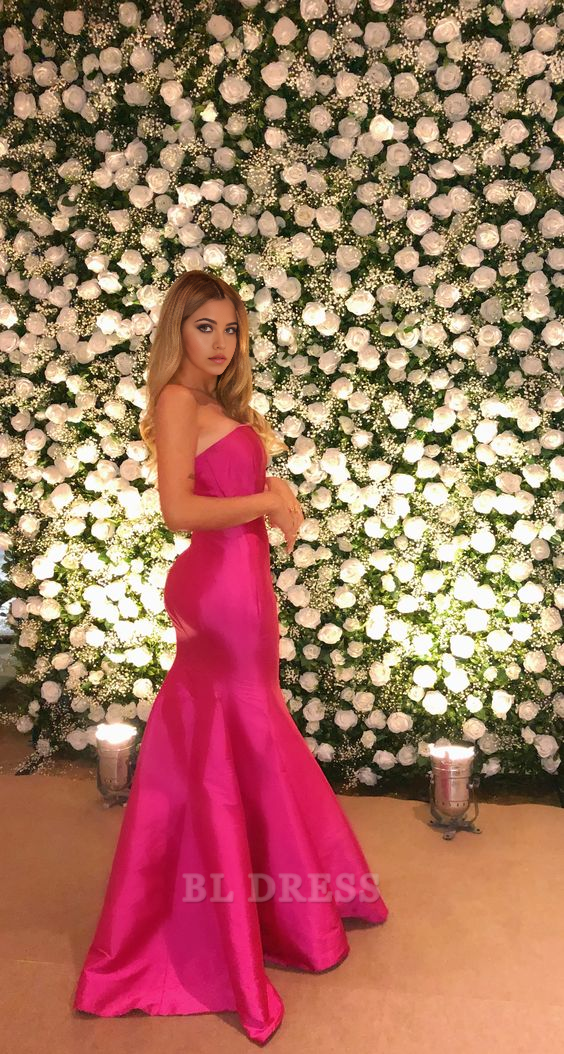 Hot pink strapless mermaid prom dress with long ruffles.