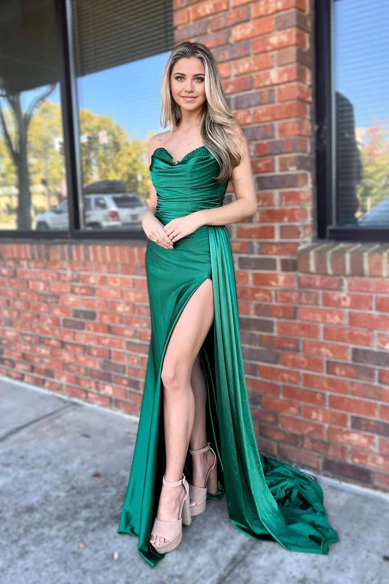 Model in a green satin mermaid prom dress with a sweetheart neckline and high slit.
