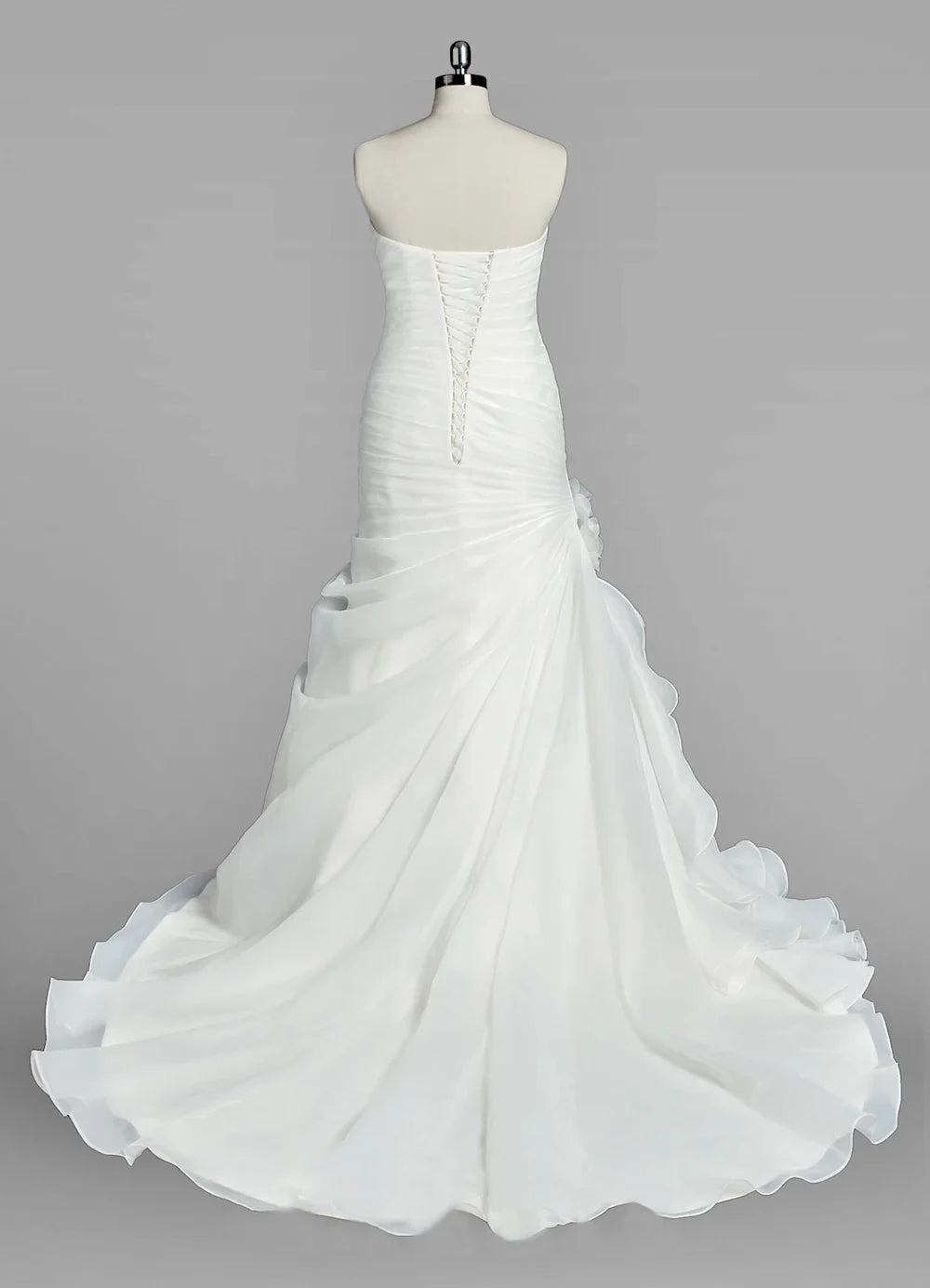 Side view of a mermaid wedding dress, showcasing delicate ruffles.