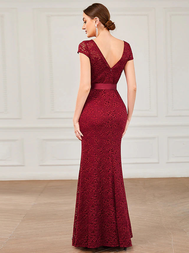 Back view of the mermaid trumpet evening gown showing the lace V-back with strappy details.