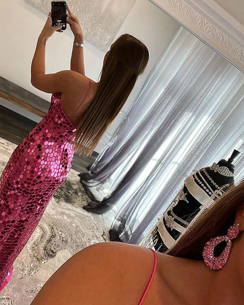 Side view of a woman in a stunning mermaid V-neck formal gown.