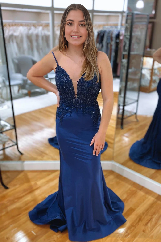 Full view of a navy blue mermaid prom dress with a V-neckline.
