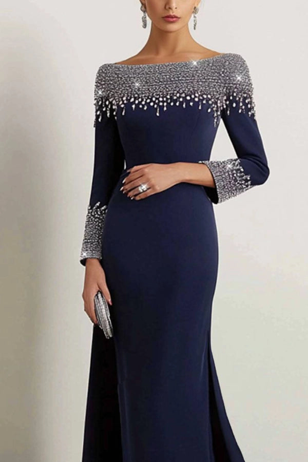 Side view of the navy boat neck rhinestone maxi dress on a model.