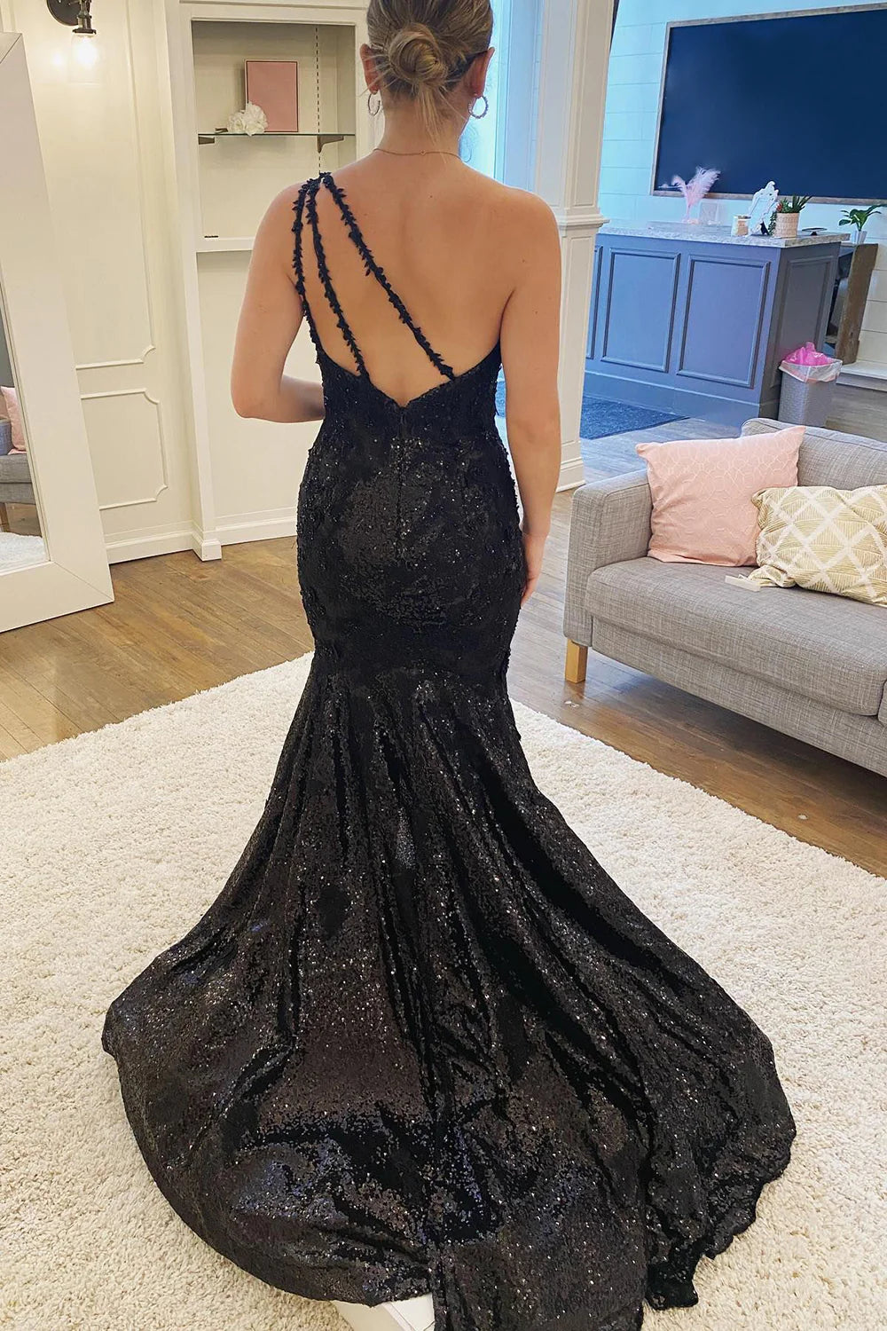 Back view of the black sequin one-shoulder mermaid formal dress.