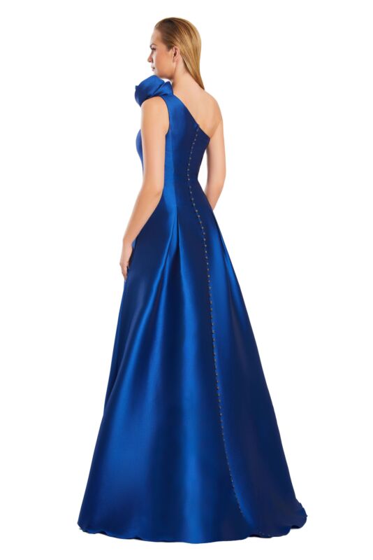 Side view of a woman in a purple one-shoulder pleated A-line prom dress.