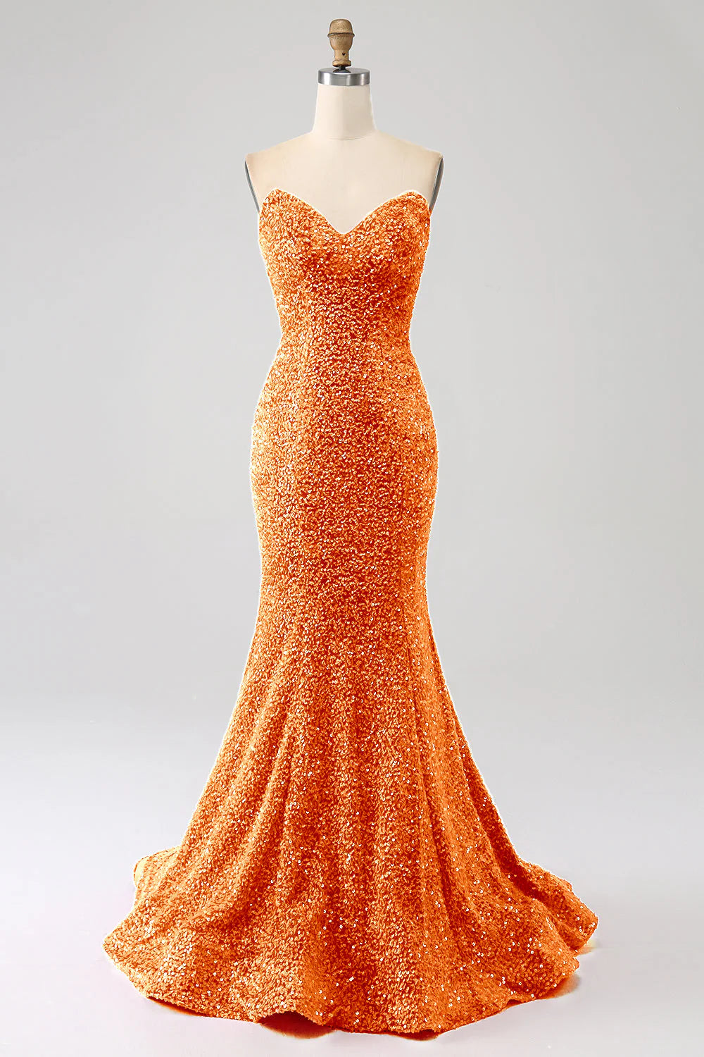 Orange mermaid prom dress with sweetheart neckline and sweep train, front view.