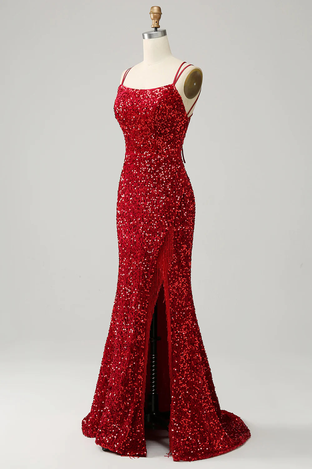 Elegant red sequined mermaid prom dress with spaghetti straps and a high slit.
