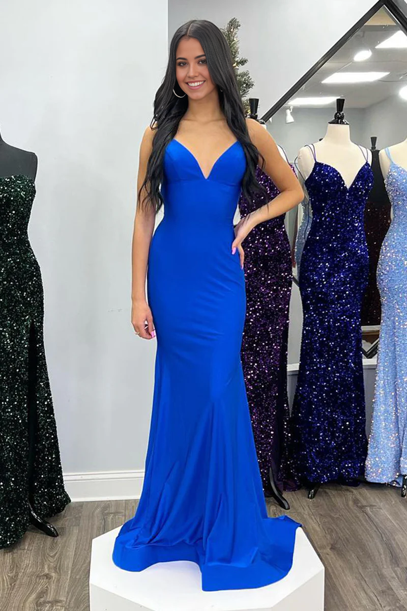 Model wearing a royal blue satin mermaid prom dress with V-neckline and elegant silhouette.
