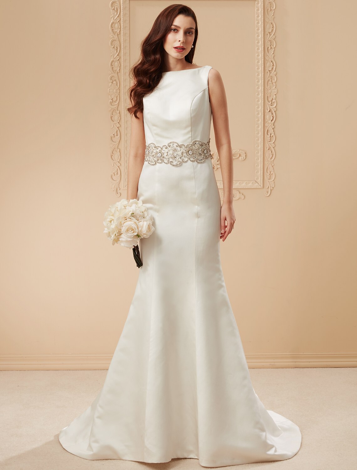 Full view of an elegant mermaid wedding dress with a chapel train, scoop neck, and intricate beading.