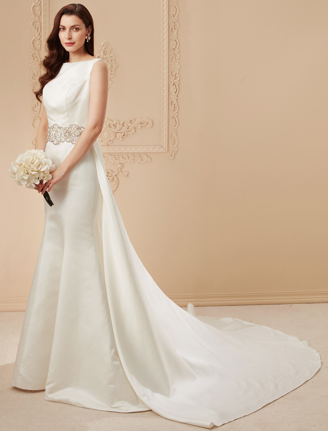 Side view of the mermaid wedding dress, highlighting the flowing chapel train and luxurious satin fabric.
