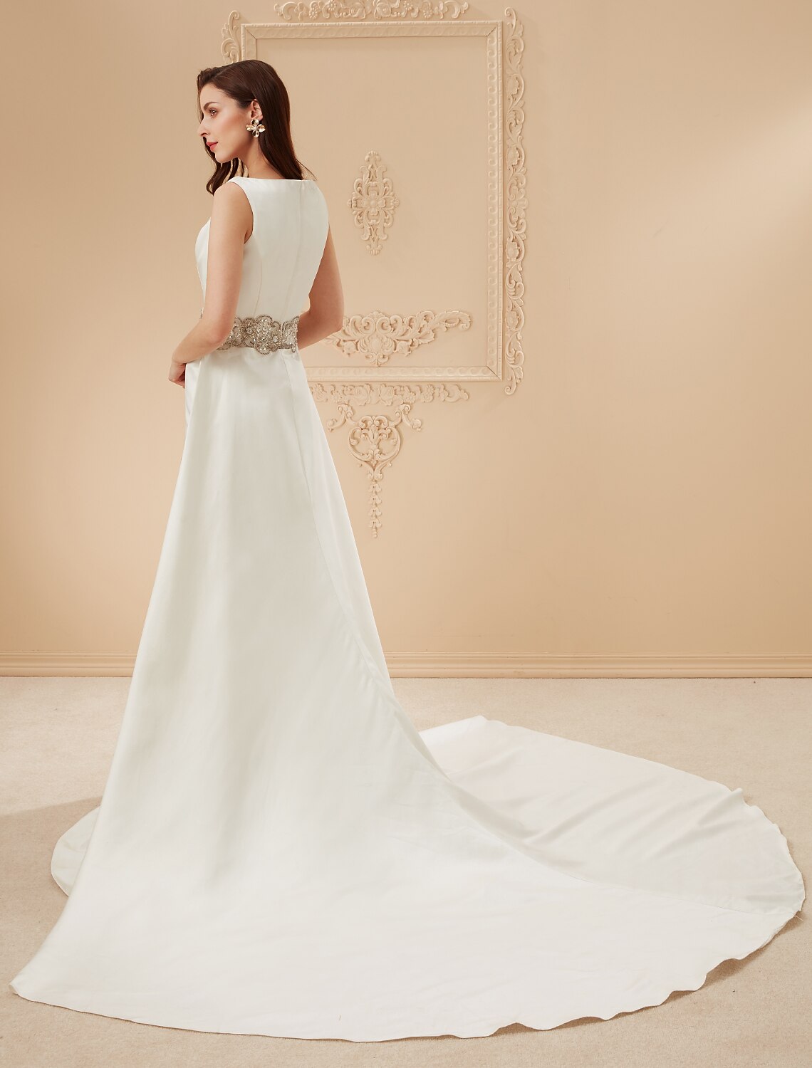 Close-up of the delicate beading details on the scoop neck of the wedding dress.