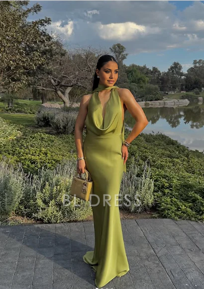 Green satin halter sheath gown, side view, showcasing the flowing maxi skirt.
