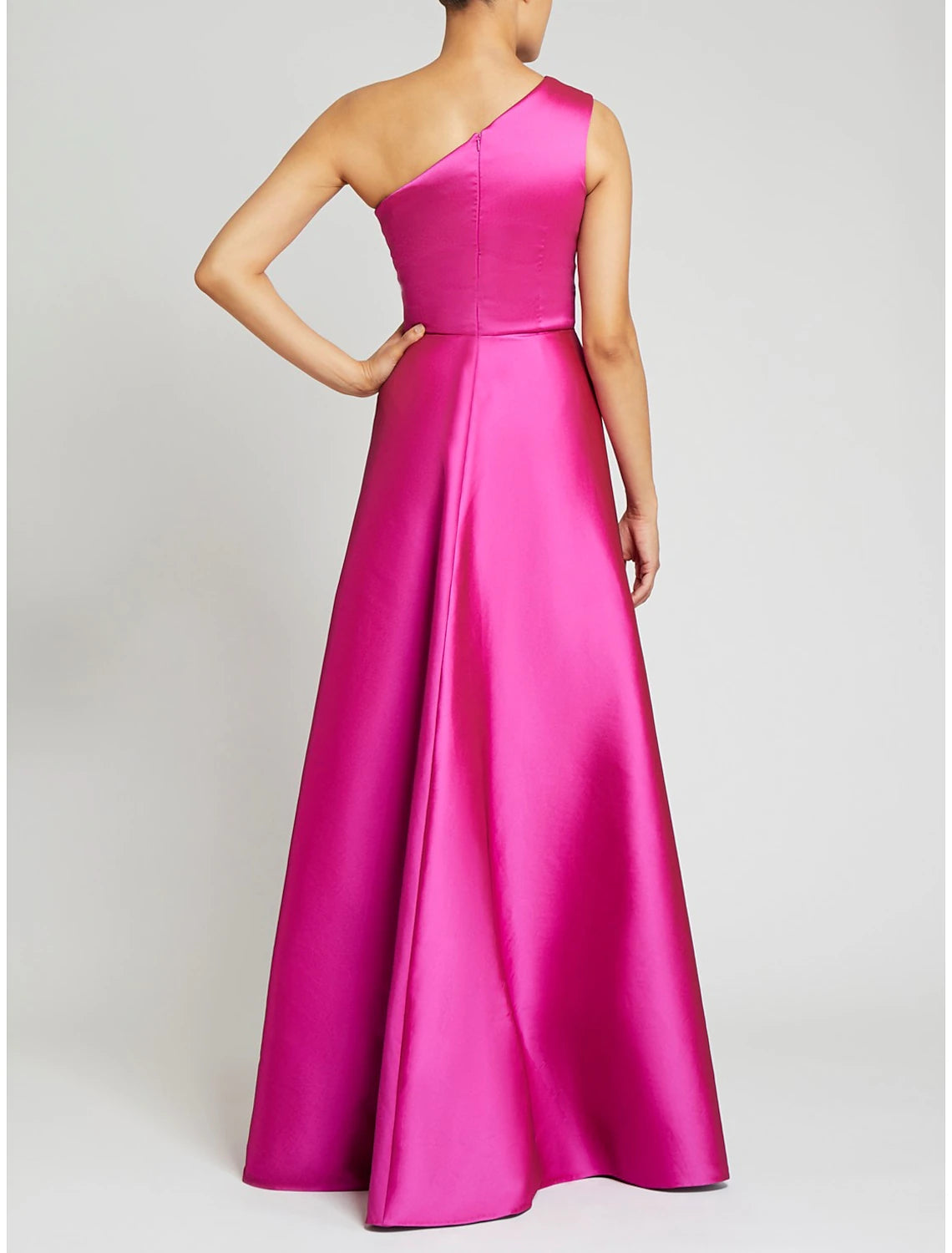 Model wearing a green one-shoulder satin sheath gown with an elegant overskirt.