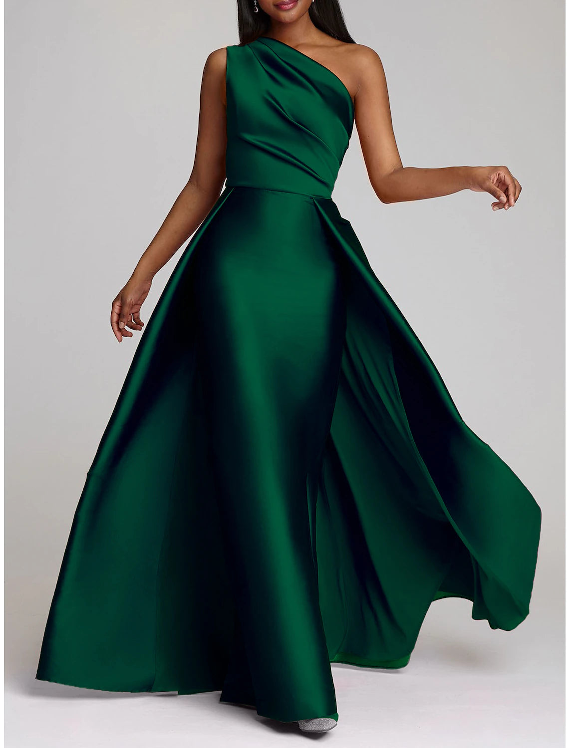Model wearing a purple one-shoulder satin sheath gown with an elegant overskirt.