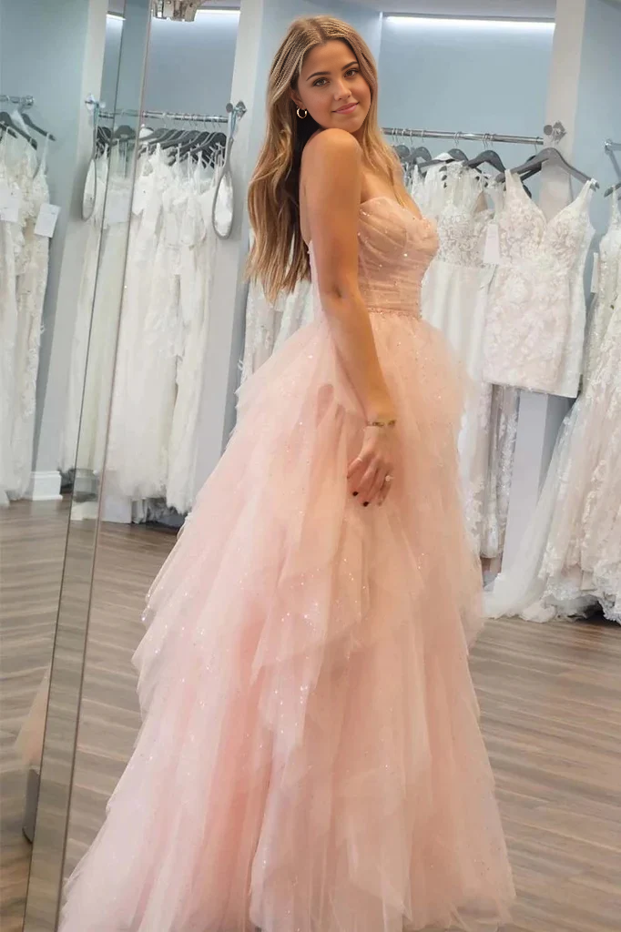 Back view of a woman showcasing the elegant train of the strapless tulle gown.