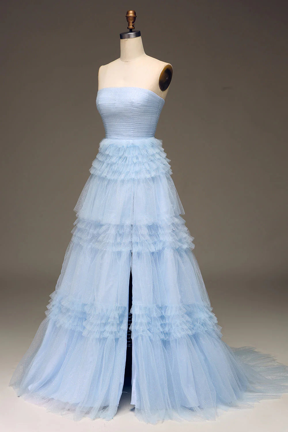 Side view of light blue tulle tiered prom dress, showing tiered skirt and slit.