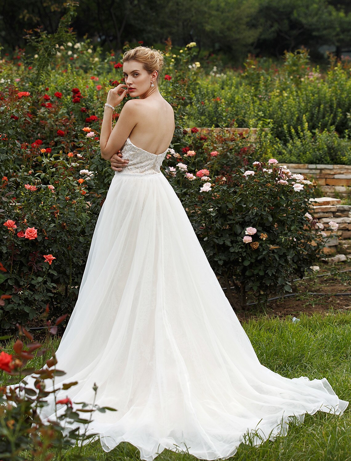 Side profile of a bride in the elegant mermaid wedding gown, highlighting its silhouette.